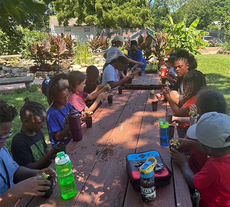 IMG_0771 Kids at camp eating at a picnic table