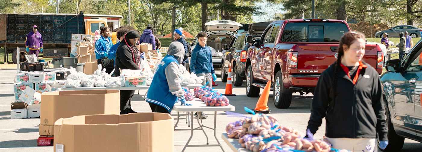 Volunteers for Harvesters outside giving out food to the community