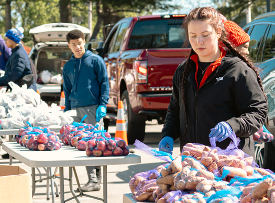 Volunteers helping give out food for Harvesters Drive